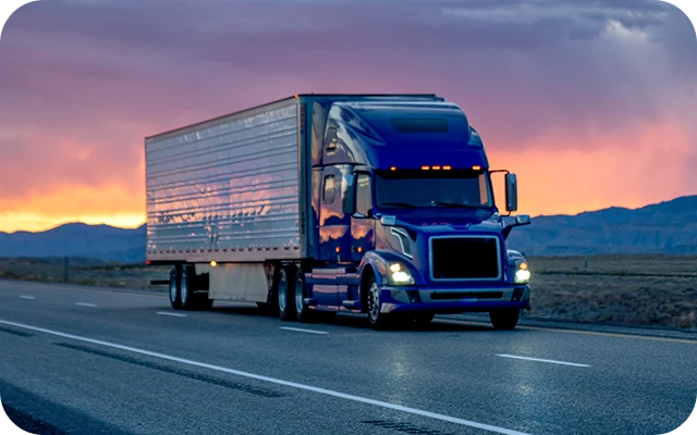 inset-semi-truck-on-hwy-at-sunset_2x.webp